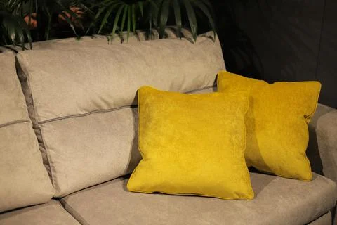 Two yellow decorative pillows on the sofa Stock Photos