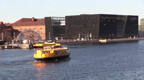 Two yellow harbour buses at the Black Diamond, the Royal Library, in Copenhagen Video stock 60604111