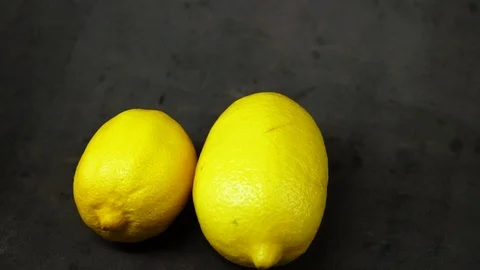 Two yellow lemons on a black background. citrus composition. Stock Footage 99500804