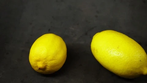 Two yellow lemons on a black background. citrus composition. Stock Footage 99500805
