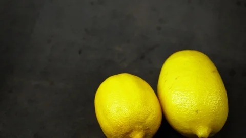 Two yellow lemons on a black background. citrus composition. Stock Footage 99500810