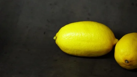 Two yellow lemons on a black background. citrus composition. Stock Footage 99500814