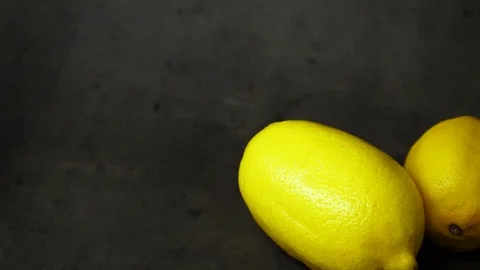 Two yellow lemons on a black background. citrus composition. Stock Footage 99500815