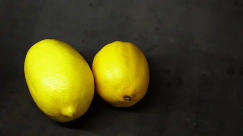 Two yellow lemons on a black background. citrus composition. Stock Footage 99500820