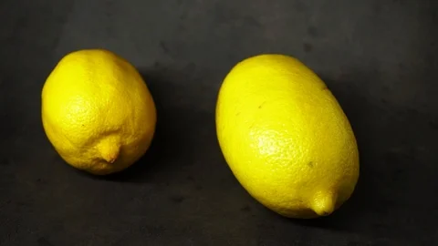 Two yellow lemons on a black background. citrus composition. Stock Footage 99500834