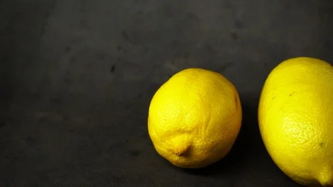 Two yellow lemons on a black background. citrus composition. Stock Footage 99500835
