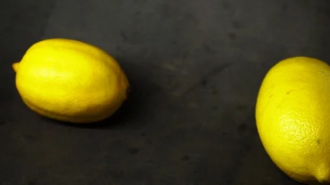Two yellow lemons on a black background. citrus composition. Stock Footage 99500843