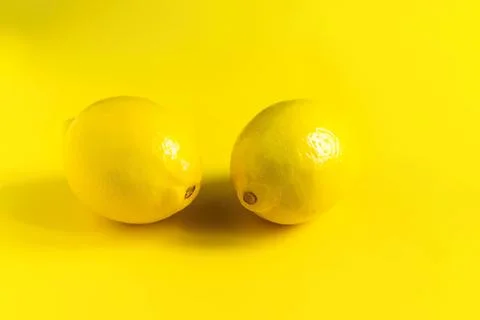 Two yellow lemons on a yellow background for fresh fruit Stock Photos