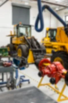 Two yellow machines parking in vector design workshop with red component, blue Stock Photos
