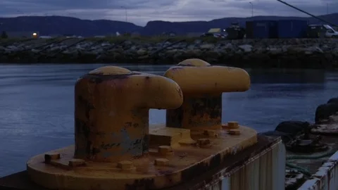 Two yellow mooring posts at night Stock Footage