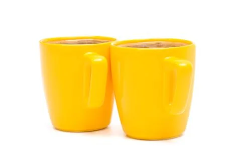 Two yellow mugs Stock Photos