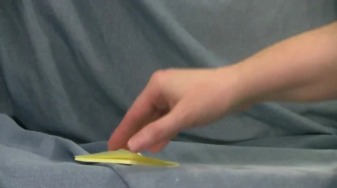 Two yellow post it notes taken from pad by hand on blue background Video stock 35533285