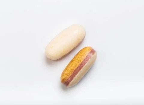 Two yellow tablets  on a white background - Image Stock Photos