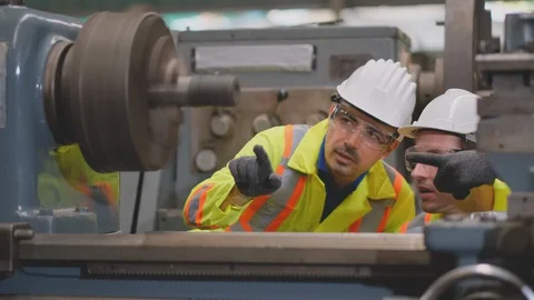 Two yellow uniform technician man work together as team to maintenance Stock Footage 129159452