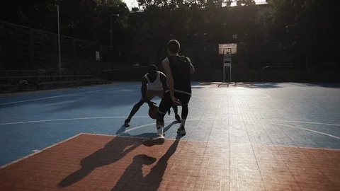 Two Young Active Mixed Race Guys Playing Basketball, Bouncing ball, One on One Stock Footage 128284562