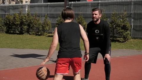 Two young active people Man play basketball game on a street sports ground Stock Footage 88357942