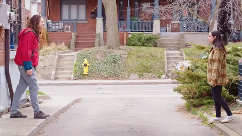 Two young adults shake hands and give a thumbs down to the camera - slow motion Stock Footage 129469674