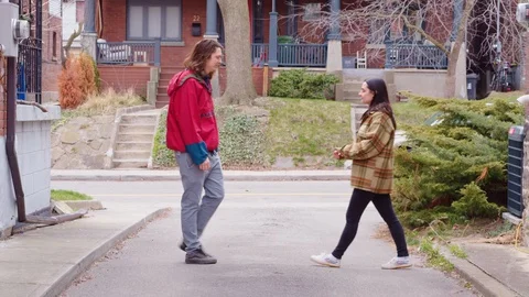 Two young adults use a measuring tape to stay a safe distance from each other - Stock Footage 129469912