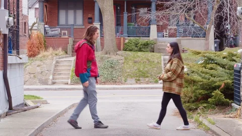 Two young adults use a measuring tape to stay a safe distance from each other Stock Footage 129901063
