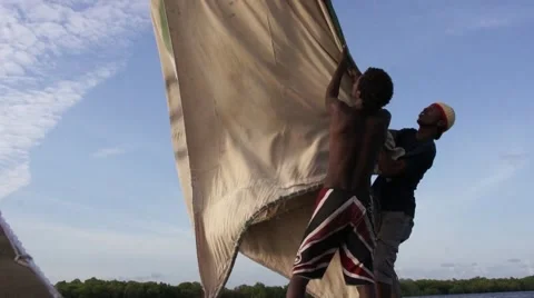 Two young Africans wrap sail, Kenya Video stock 47191106