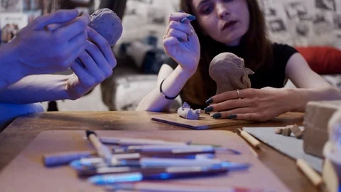 Two young artists sculpting using Plasticine Stock Footage 123446313