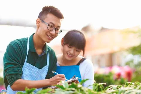 Two Young Asian Florist Working in the shop Stock Photos