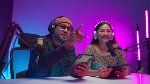 Two young asian streamer host making live podcast at broadcast home studio.  Video stock 289543051