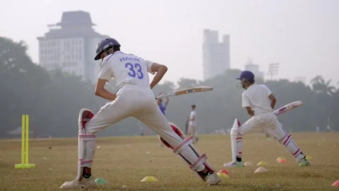 Two young aspiring players practicing batting stance in cricket training academy 動画素材 326409927