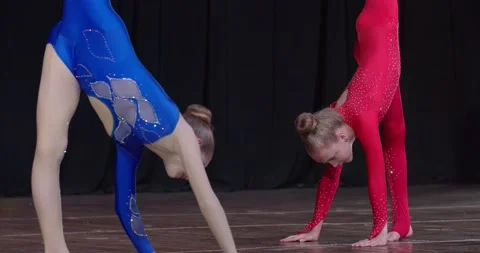 Two young athletes are performing on stage, gymnastics tournament, 4k Stock Footage 156899406