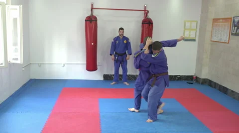 Two young athletes practicing real aikido in the gym by Pakito. Stock Footage 63160856