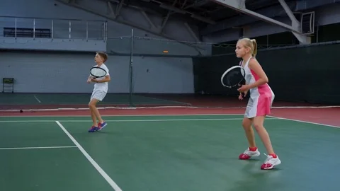 Two young athletes in recreation area playing sport game. Happy sister and Stock Footage