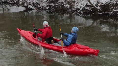Two young athletic men are having fun rowing in a red kayak. Stock-Footage 302959713