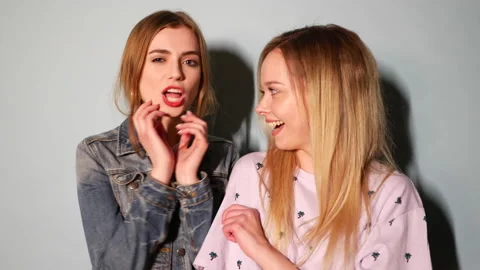 Two young beautiful blond smiling hipster girls Stock Footage 140893438