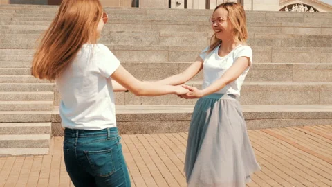 Two young beautiful blond smiling hipster girls Stock Footage 141137681