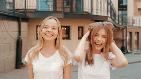 Two young beautiful blond smiling hipster girls Stock Footage 141220413