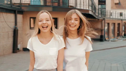 Two young beautiful blond smiling hipster girls Stock Footage 141221224