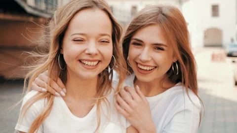 Two young beautiful blond smiling hipster girls Stock Footage 141221665