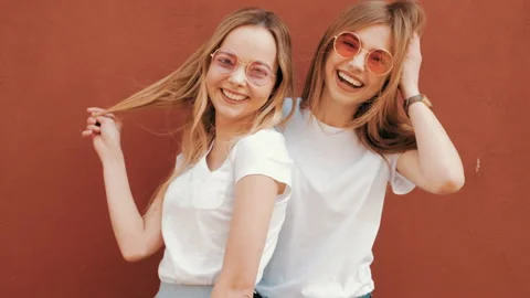 Two young beautiful blond smiling hipster girls Stock Footage 141222433