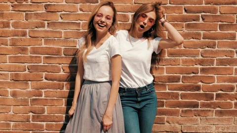 Two young beautiful blond smiling hipster girls Stock Footage 141240641