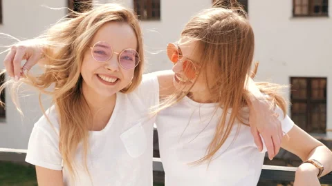 Two young beautiful blond smiling hipster girls Stock Footage 141242837