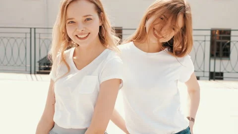 Two young beautiful blond smiling hipster girls Stock Footage 141244173