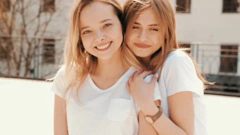 Two young beautiful blond smiling hipster girls Stockbeeldmateriaal 141244612