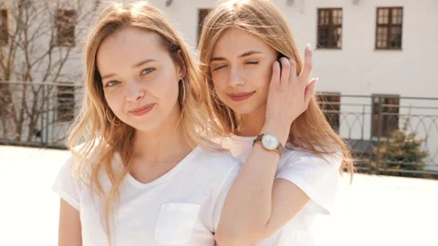 Two young beautiful blond smiling hipster girls Stock Footage 141244665