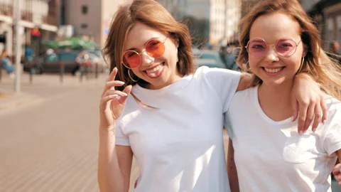 Two young beautiful blond smiling hipster girls Stock Footage 141247019