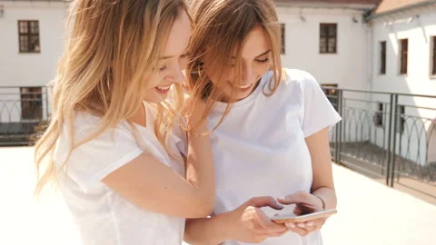 Two young beautiful smiling hipster girls Stockbeeldmateriaal 141244954