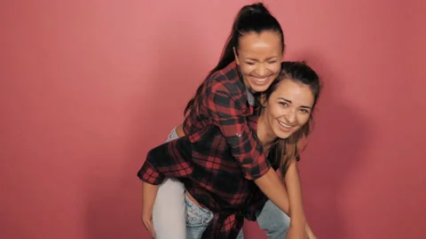 Two young beautiful smiling hipster girls Stock Footage 142004240