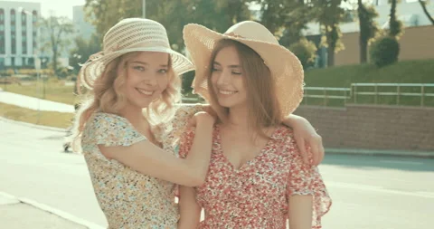 Two young beautiful smiling hipster girls in trendy dresses Stock Footage 142254959