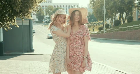 Two young beautiful smiling hipster girls in trendy dresses Stock Footage 142255294