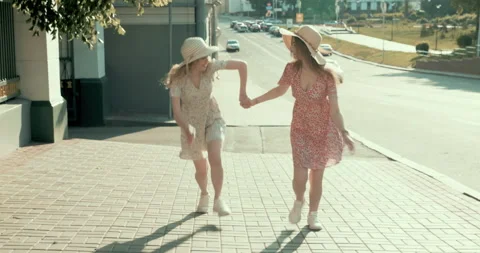 Two young beautiful smiling hipster girls in trendy summer sundress Stock Footage 142263708