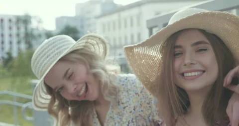 Two young beautiful smiling hipster girls in trendy summer sundress Stock Footage 142265668